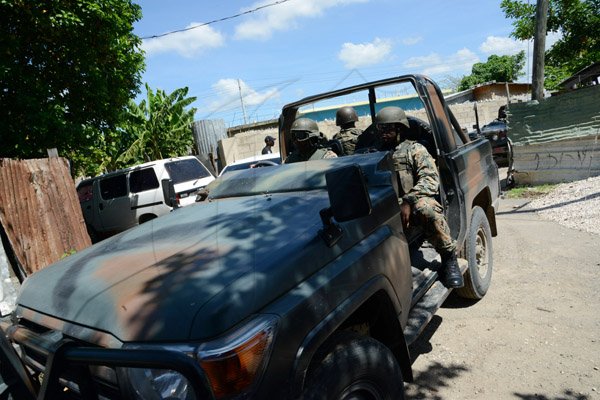 Rudolph Brown/Photographer
The Military patrolling after gunmen shoot up seven killing five including three children and set their home ablaze at Africa settlement in March Pen Community in Spanish Town on Sunday, October 9