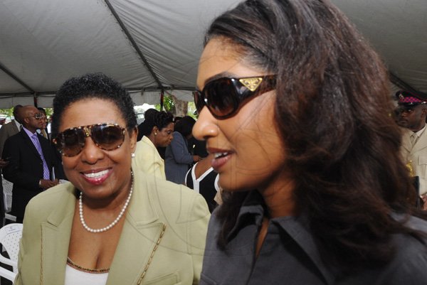 Rudolph Brown/Photographer
Olivia Grange, (left) Opposition Spokesperson on Youth, Sports chat with Hanna, Minister of Youth and Culture, at the Floral Tribute commemorating the 125th Anniversary of the birth The Rt. Excellent Marcus Mosiah Garvey, Jamaica National Hero at the National Heroes Park in Kingston on Friday, August 17-2012