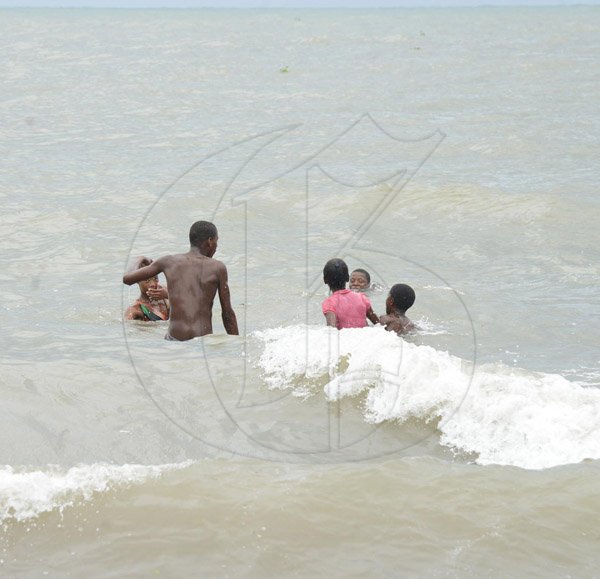 Ian AllenA group of children splash in the brackish  sea water where Annotto River in Annotto Bay St Mary connects to the sea as Hurricane Matthew approaches the east end of the island.