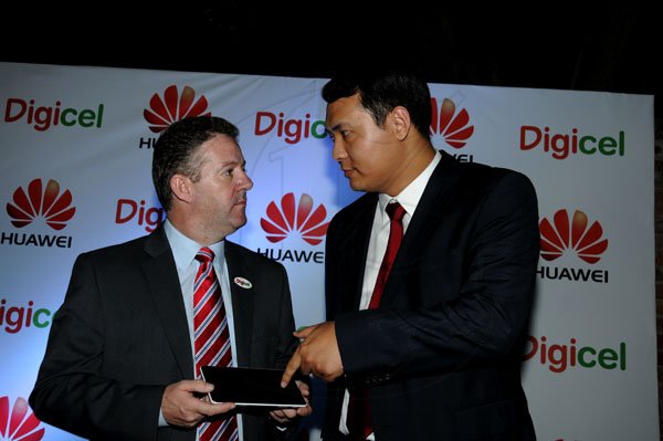 BUSINESS DESK
Winston Sill / Freelance Photographer
Digicel and Huawei presents the launch of the new Huawei Media Pad, held at Devon House, Hope Road on Monday night November 12, 2012. Here are Andy Thorburn (left), DEO, Digicel; and Vincent Wen (right), Sales Director, Central America and the Caribbean, Huawei.