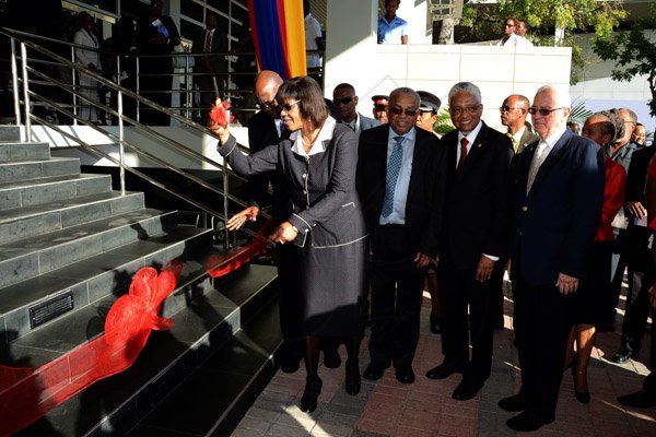 Winston Sill/Freelance Photographer
Prime Minister Portia Simpson-Miller opens UWI's   Faculty of  Medical Sciences' Teaching and Research Complex, and Launch of The UWI, Mona Dental Programme, held at West Road, UWI  Mona Campus, on Wednesday February 4 , 2015. Here Prime Minister Portia Simpson-Miller (left) cuts the ribbon to opren the building;,  looking-on are Prof. Archibald McDonald (second left), Principal, UWI, Mona; Prof. E. Nigel Harris (second right), Vice-Chancellor; and Minister of Education Ronald Thwaites (right).