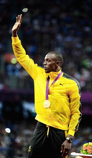 Ricardo Makyn/Staff Photographer
Jamaica's Usain Bolt waves from the podium during the Olympic Games medal ceremony for the men's 100 metres final, at London Olympic Stadium yesterday. Bolt won the gold medal in 9.63 seconds, the second fastest time in history.