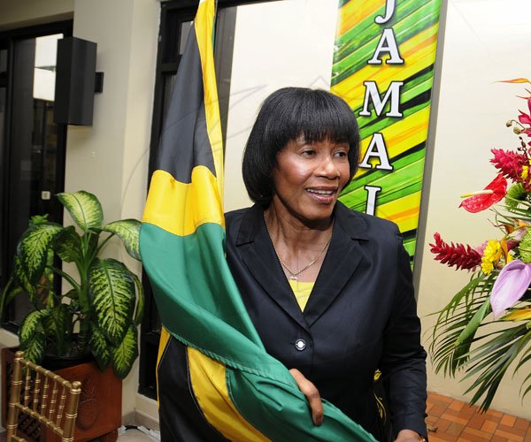 Gladstone Taylor / Photographer

A jubilant Prime Minister Portia Simpson Miller embraces the Jamaican flag after Usain Bolt and Yohan Blake finished one-two in men's Olympic 100-metre final yesterday. Simpson Miller and guests watched the final at the Office of the Prime Minister. 

yesterday afternoon  to the 100m olympic finals as seen at the office of the prime minister yesterday afternoon
