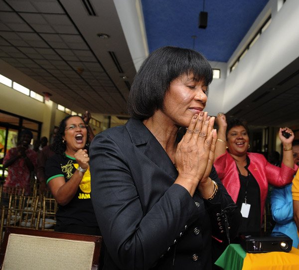 Gladstone Taylor / Photographer

Jamaican Prime Minister Portia Simpson Miller says a quiet word of prayer after Usain Bolt and Yohan Blake finished one-two in men's Olympic 100-metre final yesterday. Simpson Miller and guests watched the final at the Office of the Prime Minister.

 yesterday afternoon