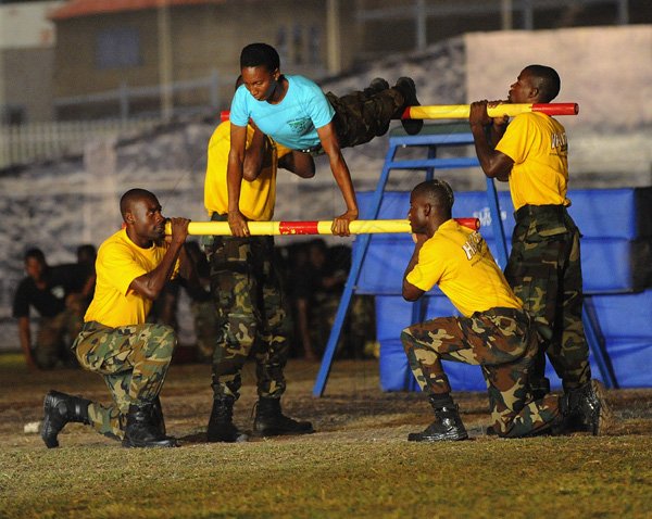 Ian Allen/Photographer
Now that takes skill. Members of the Jamaica Defence Force participate in physical education drills at the Jamaica Military Tattoo 2012 at Up Park Camp on Thursday June 28.