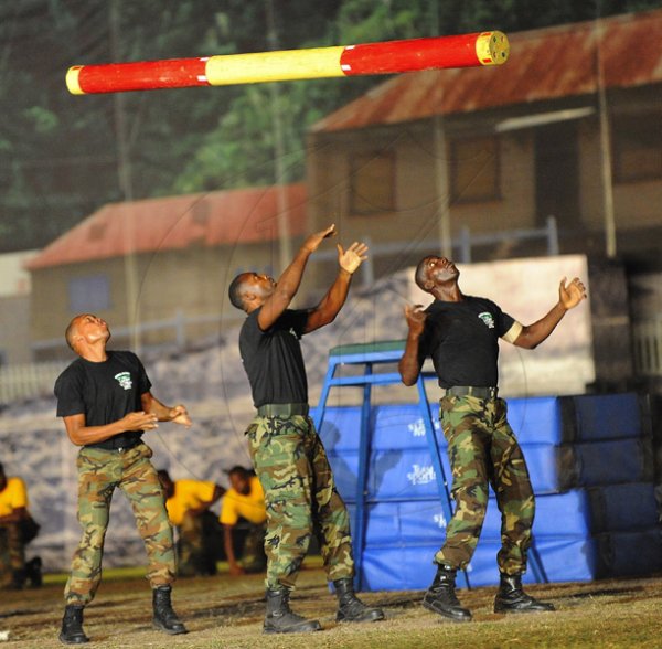 Ian Allen/Photographer
Members of the Jamaica Defence Force show their strength by tossing logs back and forth at the Jamaica Military Tattoo 2012 at Up Park Camp on Thursday June 28.
