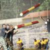 Ian Allen/Photographer
Members of the Jamaica Defence Force show their strength by tossing logs back and forth at the Jamaica Military Tattoo at Up Park Camp on Thursday June 28.  Jamaica Defence Force(JDF) Military Tattoo at Up Park Camp.