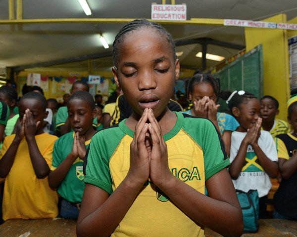 Ian Allen/Photographer
Students at Mount Olivet Primary School in Manchester having devotion during the Opening of their Word Wall and Commissioning of Reading Monitors at the school on Friday, 27, 2015.