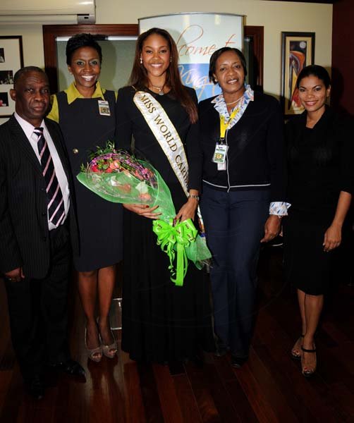 Winston Sill/Freelance Photographer
Miss Jamaica World 2013 and Miss World Caribbean Gina Hargitay return from Miss World Contest, at Norman Manley International Airport on Monday October 14, 2013. Here are Sidney Bartley (left), of the Ministry of Youth and Culture;  Grace Morrison (second left), Marketing and Corporate Communications Manager, Airports Authority of Jamaica; Gina Hargitay (centre); Andrea Francis (second right); and Laura Butler (right).