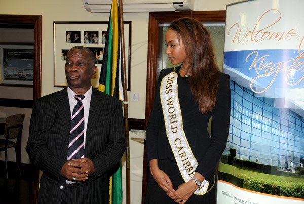 Winston Sill/Freelance Photographer
Miss Jamaica World 2013 and Miss World Caribbean Gina Hargitay return from Miss World Contest, at Norman Manley International Airport on Monday October 14, 2013. Here are Sidney Bartley (left), of the Ministry of Youth and Culture; and Gina Hargitay (right).