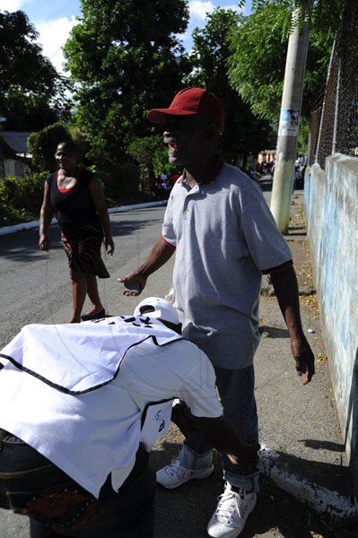 Ricardo Makyn/Staff Photographer
Election Day
A Elderly being searched by a one day Police before entering the Polling Station  at the Seaforth Primary School in Western St Thomas.