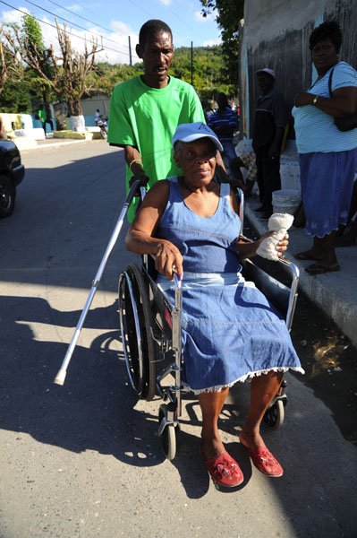 Ricardo Makyn/Staff Photographer
Election Day
A Elderly Lady that's wheel chairedbound being assisted to the Polling Station in Seaforth in Western St. Thomas