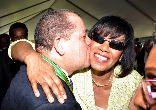 Jermaine Barnaby/Photographer
Audley Shaw plants a kiss on the cheek of Prime Minister Portia Simpson Miller as he greeted her following accepting the Order Of Distinction Commander on Heroes Day during a ceremony at Kings House on Monday October 21, 2013.