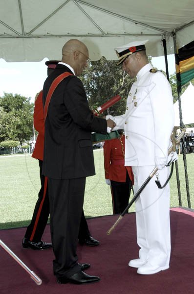 Ricardo Makyn/Staff Photographer.
Governor General Sir Patrick Hall (left) officially appoints Captain George Reynolds as a member of the Order of Distinction - Officer class for his service to the Jamaica Defence Force.

Ceremony of Investiture and presentation of National Awards 2010 at Kings House