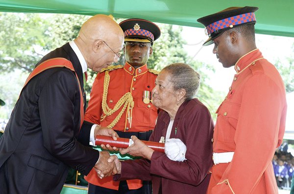 Lionel Rookwood/PhotographerMajorie Dlores Parkin accepts The Badge Of Honour for Long and Faithful Service from Governor General Sir Patrick Allen at The National Honours and Awards held at King's House yesterday.