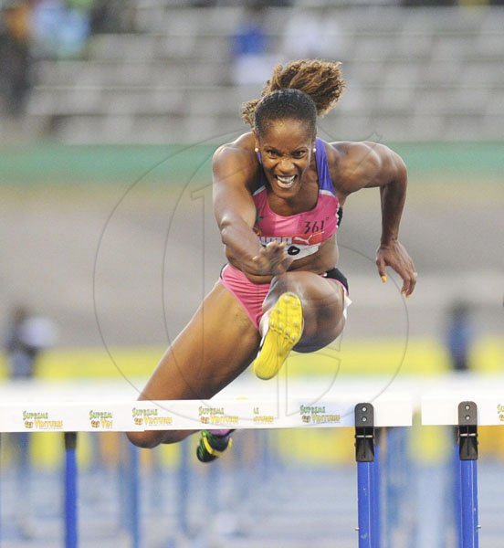 Ricardo Makyn/Staff Photographer
Brigitte Foster-Hylton clears the hurdle on the way to winning the women's 100 metres hurdles final at the JAAA/Supreme Ventures National Senior Track and Field Athletics Championships at the National Stadium on Sunday night.