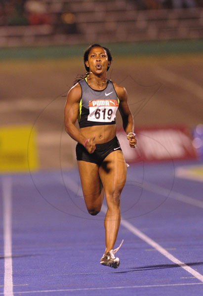 Ricardo Makyn/Staff Photographer
Shelly-Ann Fraser-Pryce (right) runs on her way to winning the women's 200 metres final at the JAAA/Supreme Ventures National Track & Field Championships at the National Stadium on Sunday night.