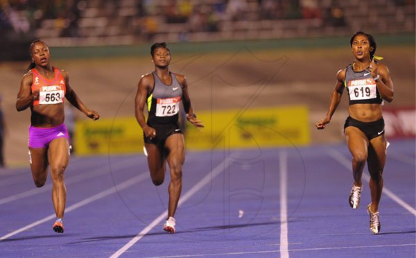 Ricardo Makyn/Staff Photographer
Shelly-Ann Fraser-Pryce (right) races ahead of Anneisha McLaughlin (centre) and Veronica Campbell-Brown on her way to winning the women's 200 metres final at the JAAA/Supreme Ventures National Track & Field Championships at the National Stadium on Sunday night.