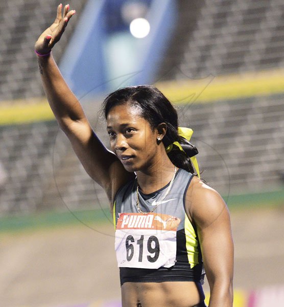 Ricardo Makyn/Staff Photographer
Shelly-Ann Fraser-Pryce waves to fans after winning the women's 200 metres final at the JAAA/Supreme Ventures National Track & Field Championships at the National Stadium on Sunday night.