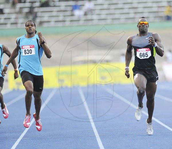 Ricardo Makyn/Staff Photographer
Dae Hyatt rruns ahead of Jermaine Gonzales (left) to win the men's 400 metres final at the JAAA/Supreme Ventures National Senior Track and Field Athletics Championships at the National Stadium on Sunday night.