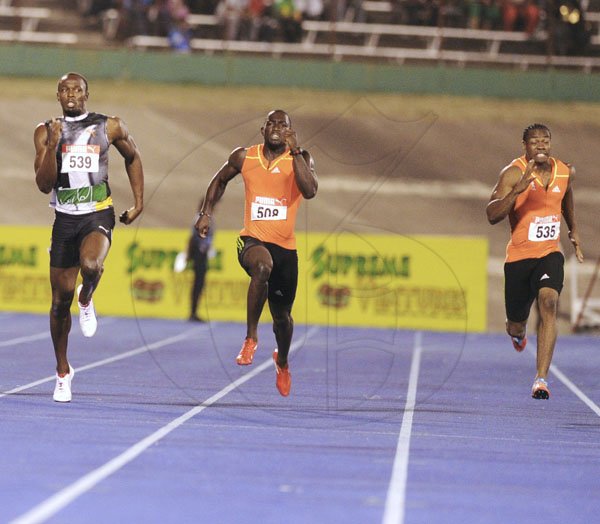 Ricardo Makyn/Staff Photographer
Yohan Blake (right) battles with Usain Bolt (left) and Nickel Ashmeade (centre) on the way to winning the men's 200 metres final at the JAAA/Supreme Ventures National Senior Track and Field Athletics Championships at the National Stadium on Sunday night.