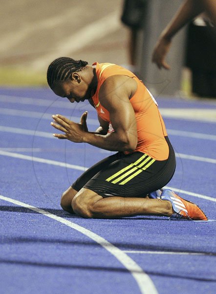 Ricardo Makyn/Staff Photographer
Yohan Blake kneels and poises in prayer mode after winning the men's 200 metres final at the JAAA/Supreme Ventures National Senior Track and Field Athletics Championships at the National Stadium on Sunday night.
