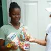 Ian Allen/Staff Photographer
Diana Birch right, Coordinator for Brand Promoters  in the Nestle "Knock at the Gate" Promotions, presents Shavone Richards left with a gift after she produce the enough empty Nestle package to qualify for a gift. Nestle was in the Stony Hills and Golden Spring promoting their products.