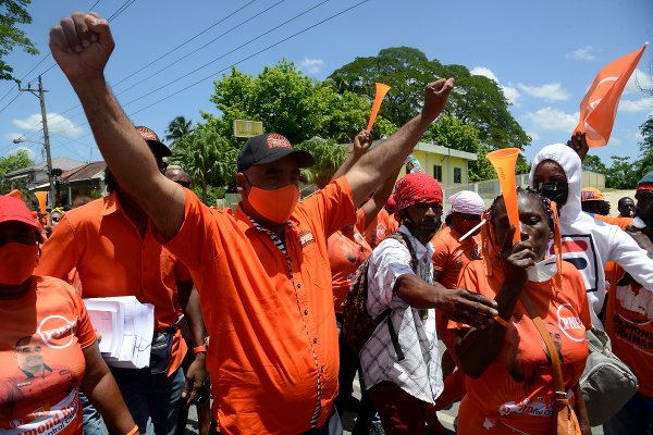 The crowd rush to Dr. Desmond Brennan, PNP candidate for Clarendon North Central, as he exited the Chapelton Family Court with his hands in the air at Main Street Chapelton, on August 18, 2020.