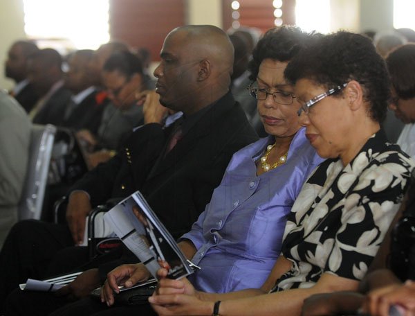 Gladstone Taylor / Photography

Onel Williams Jnr. (left) , Joy Williams (wife)  and sister in law Clover Bailey (right) as seen at the Thanks giving service for the life of Onel Williams