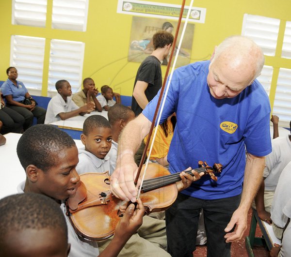 Gladstone Taylor / Photographer

Andrew Williams of the Royal Philharmonic Orchestra (right) shows Donhue Johnson from alpha boys home how to hold violin

Royal Philharmonic Orchestra visits Alpha boys home yesterday morning