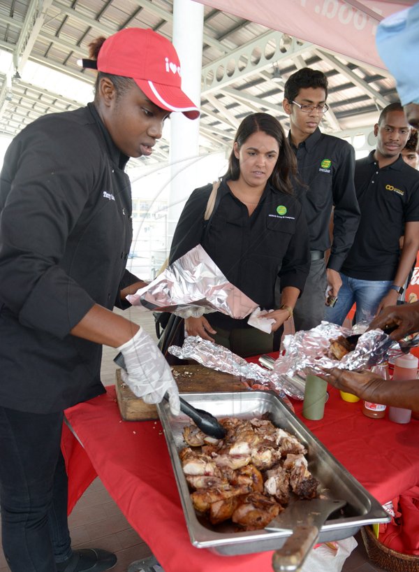 Ian Allen/PhotographerLaunch of the Pan Chicken Festival 2017 at the Half Way Tree Transport Center. *** Local Caption *** Ian Allen/PhotographerChef Terry Ann Davidson (left) serves up samples of her trade-mark pan chicket at yesterday's launch of Pan 2017 at the Half Way Tree Transport Centre in St Andrew yesterday.