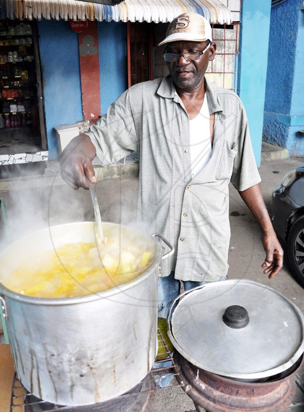 Jermaine Barnaby/Photographer
Brenton Clarke better known as soupy looks after his regular Saturday pot of soup inside the St Ann's Bay Market during a tour of parish capital, St Ann's Bay on Saturday March 21, 2014.