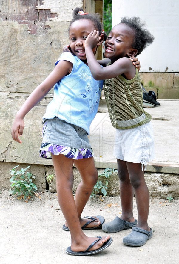 Shantol Thomas (left) was caught having fun with friend Towannie Wilson in the Riverlane community of Windsor in St Ann's bay during a tour of parish capital, St Ann's Bay on Saturday March 21, 2014.