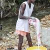 Jermaine Barnaby/Photographer
Kareen Clarke carries out her domestic chores at Whiteriver during a tour of parish capital, St Ann's Bay on Saturday March 21, 2014.