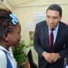 Rudolph Brown/Photographer
Opposition Leader Mr. Andrew Holness chat to Shaniel Allen, (left) during speaking to grade seven four students on value and Attitude while Kadine Foster, (right) looking on on Teachers' Day at Penwood High School on Rhoden Crescent in St. Andrew on Wednesday, May 8, 2013