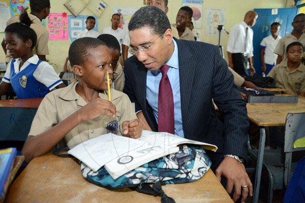 Rudolph Brown/Photographer
Opposition Leader Mr. Andrew Holness chat with Rajaughn Searchwell after speaking to grade seven four students on value and Attitude on Teachers' Day at Penwood High School on Rhoden Crescent in St. Andrew on Wednesday, May 8, 2013