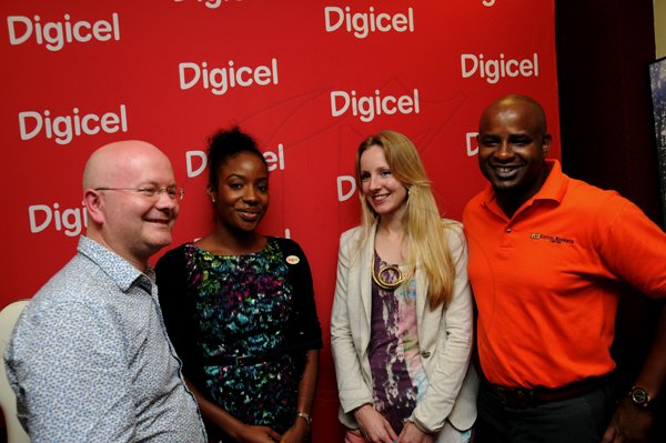 Winston Sill / Freelance Photographer
Arrival of The Royal Philharmonic Orchestra members, at Norman Manley International Airport on Monday September 10, 2012. Here are Benjamin Pope (left), Conductor, Royal Philharmonic Orchestra; Tahnida Nunes (second left), Sponsorship Manager, Digicel; Ruth Currie (second right), Head of Community and Education, Royal Philharmonic Orchestra; and Julian Patrick (right), Sponsorship and Promotions Manager, NCB.