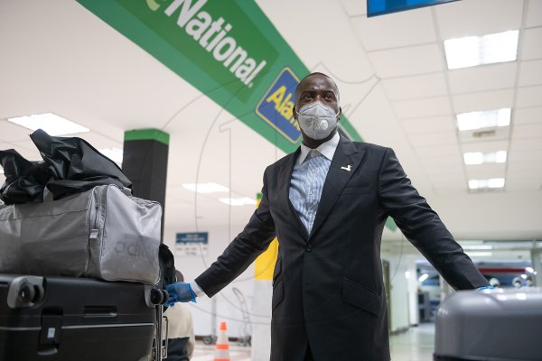 A relieved Michael Forrester stands with his luggage at the Norman Manley International Airport yesterday evening. One hundred and fifteen Jamaicans, including 75 ship workers, landed in Kingston after being stranded for weeks in the United Kingdom. The group arrived aboard a TUI charter flight.