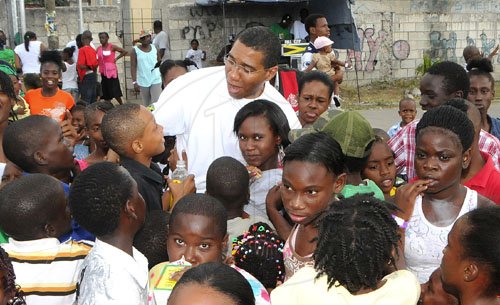 JIS/Photograph                                                                                                                                                                        Pics from PM?s Treats                                                                                                                                                             Prime Minister Andrew Holness speaks with children from his West Central St. Andrew constituency during a treat he hosted for them at the Olympic Gardens community centre, Olympic Way on Sunday, December 25.