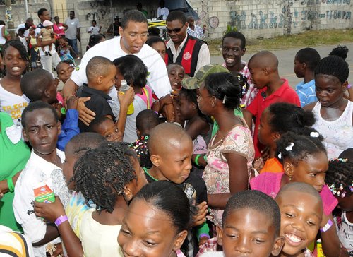 JIS/Photograph                                                                                                                                                                        Pics from PM?s Treats                                                                                                                                                             Prime Minister  Andrew Holness is swamped by children from his West Central St. Andrew constituency at his treat for them at the Olympic Gardens community centre, Olympic Way, on Sunday, December 25.