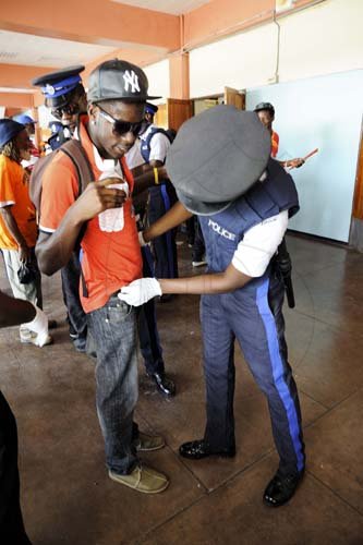 Ricardo Makyn/Staff Photographer
Policemen search individuals entering the arena for the conference.