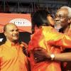 Ricardo Makyn/Staff Photographer
Former prime minister PJ Patterson receives  a kiss from People's National Party (PNP) President Portia Simpson Miller while General Secretary Peter Bunting looks on during the  PNP's 73rd Annual Conference at the National Arena yesterday.
