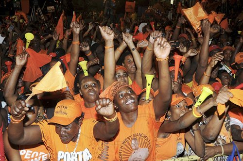 Ian Allen/Photographer 
People's National Party (PNP) supporters in a festive mood at their Mandeville, Manchester, mass rally on Sunday.