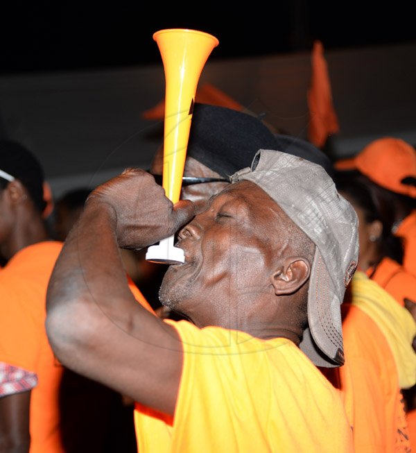 Jermaine Barnaby/Photographer
A PNP supporters blowing a vuvuzela at the rally in Black River, St. Elizabeth on Sunday November 22, 2015.
