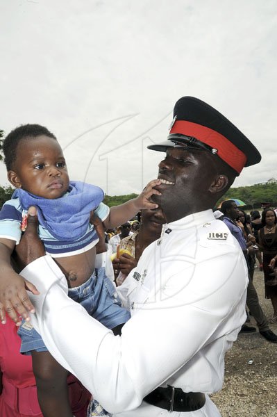 Norman Grindley/Chief Photographer
Andre Alder greets his seven-month-old nephew Khalil Walker, at the end of his graduation ceremony yesterday at the Jamaica police academy in Twickenham park St. Catherine yesterday.