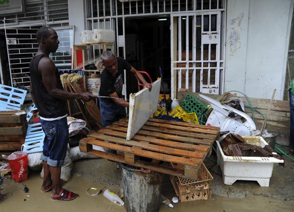 Ricardo Makyn/Staff Photographer
Business owners and workers doing clean up operations after flooding in   Port Maria St Mary