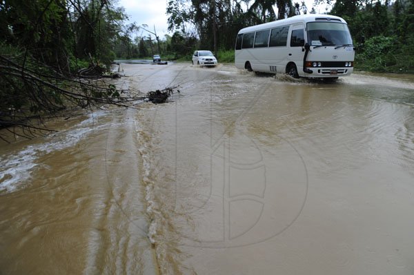 Ricardo Makyn/Staff Photographer
 Flooded main road in the Rosen Community St Mary