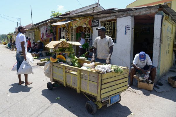 Gladstone Taylor / Photographer

Food Vendors along port maria main road, with the scarcity of people in the port maria market some have found it more lucrative to sell their goods else where.

Parish capital feature on Port Maria.