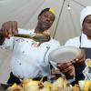 Rudolph Brown/Photographer
Chef Dennis McIntosh, (left) with chef Sharon Byfield serve jerk chicken Kebabs with vegetables at the Best Dressed Chicken Portland Jerk Festival at Folly Ruins in Portland on Sunday, July 7, 2013