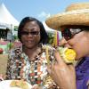 Rudolph Brown/Photographer
Carol Forrest, (left) looking at Audrey Argun eating corn at the Best Dressed Chicken Portland Jerk Festival at Folly Ruins in Portland on Sunday, July 7, 2013